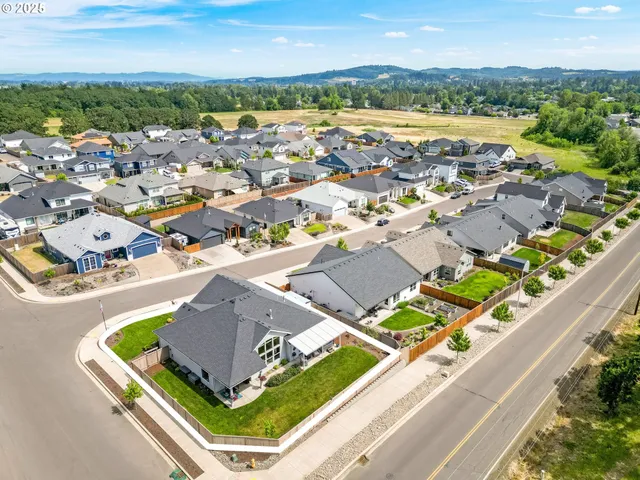 an aerial view of residential houses with outdoor space