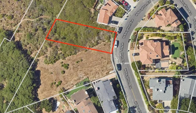 an aerial view of a house with a yard and lake view