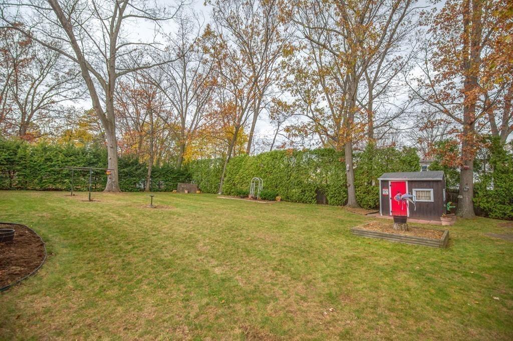 154 Prouty Street Springfield, MA 01119 - Photo 21 of 26 a sign board in front of a big yard with large trees