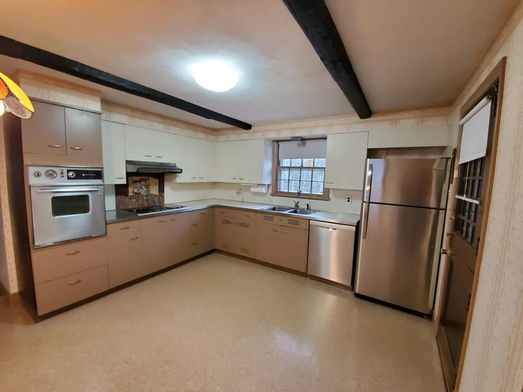 154 Prouty Street Springfield, MA 01119 - Photo 6 of 26 a kitchen with stainless steel appliances a refrigerator sink and cabinets