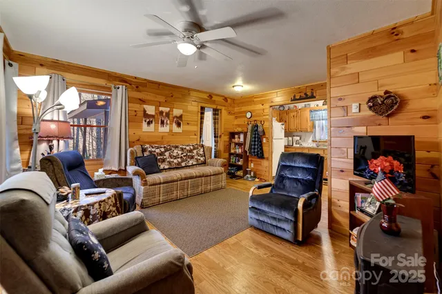 a living room with furniture a rug and a chandelier
