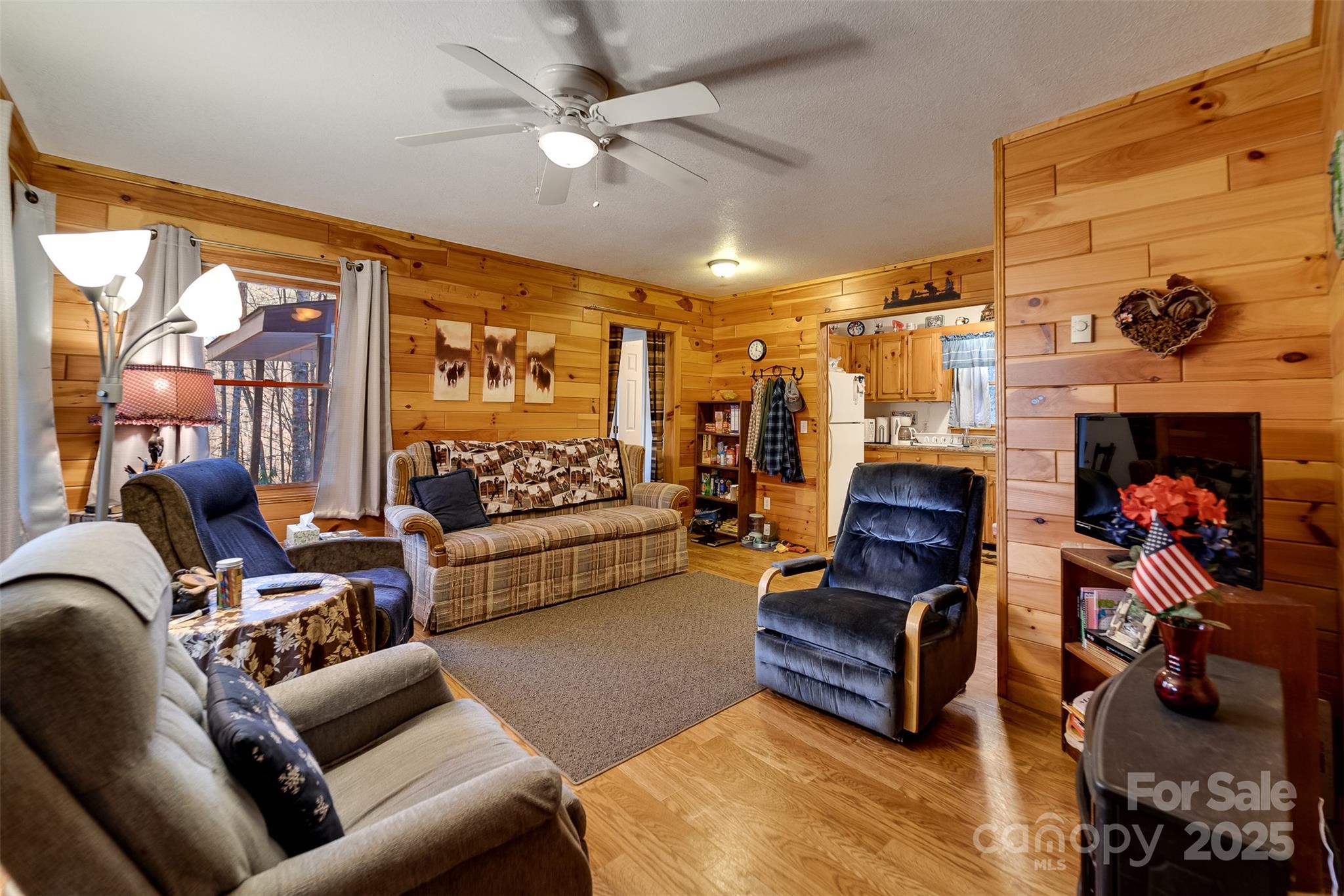 109 Hog Cove Road Sylva, NC 28779 - Photo 12 of 48 a living room with furniture a rug and a chandelier