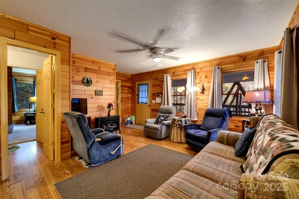 a living room with furniture ceiling fan and a rug