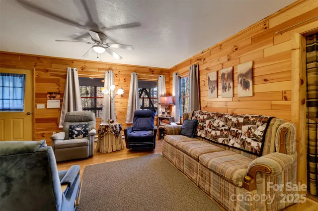 a living room with furniture ceiling fan and a rug