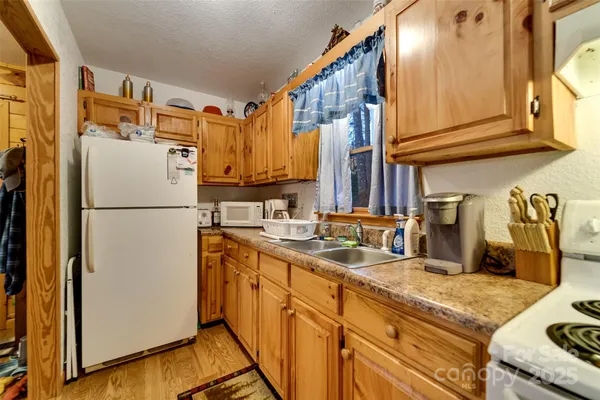 a kitchen with refrigerator and cabinets
