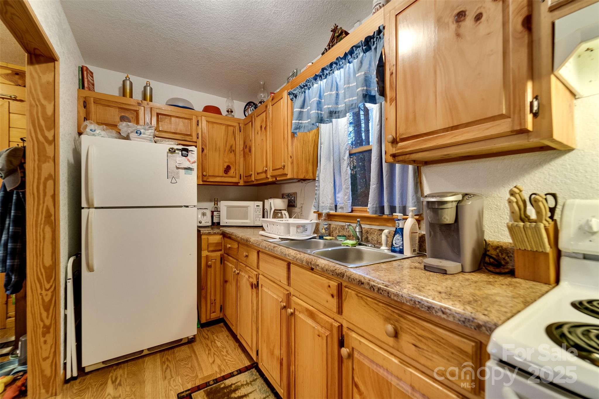 109 Hog Cove Road Sylva, NC 28779 - Photo 16 of 48 a kitchen with refrigerator and cabinets