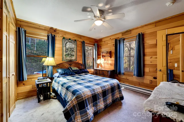 a bedroom with a bed and a large window with balcony view