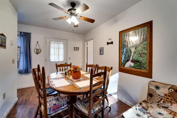 a view of a dining room with furniture and chandelier