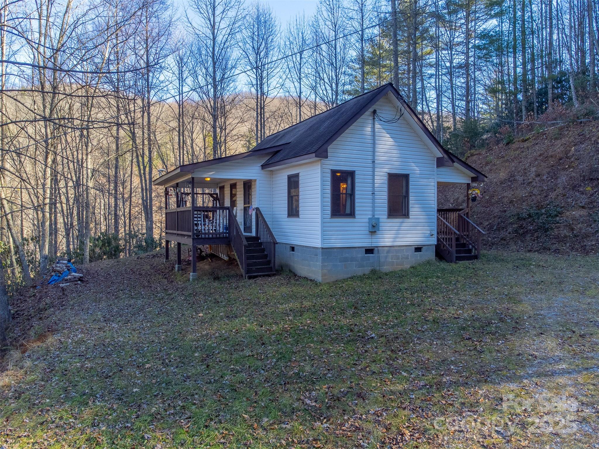 109 Hog Cove Road Sylva, NC 28779 - Photo 3 of 48 a view of a house with a yard and large trees