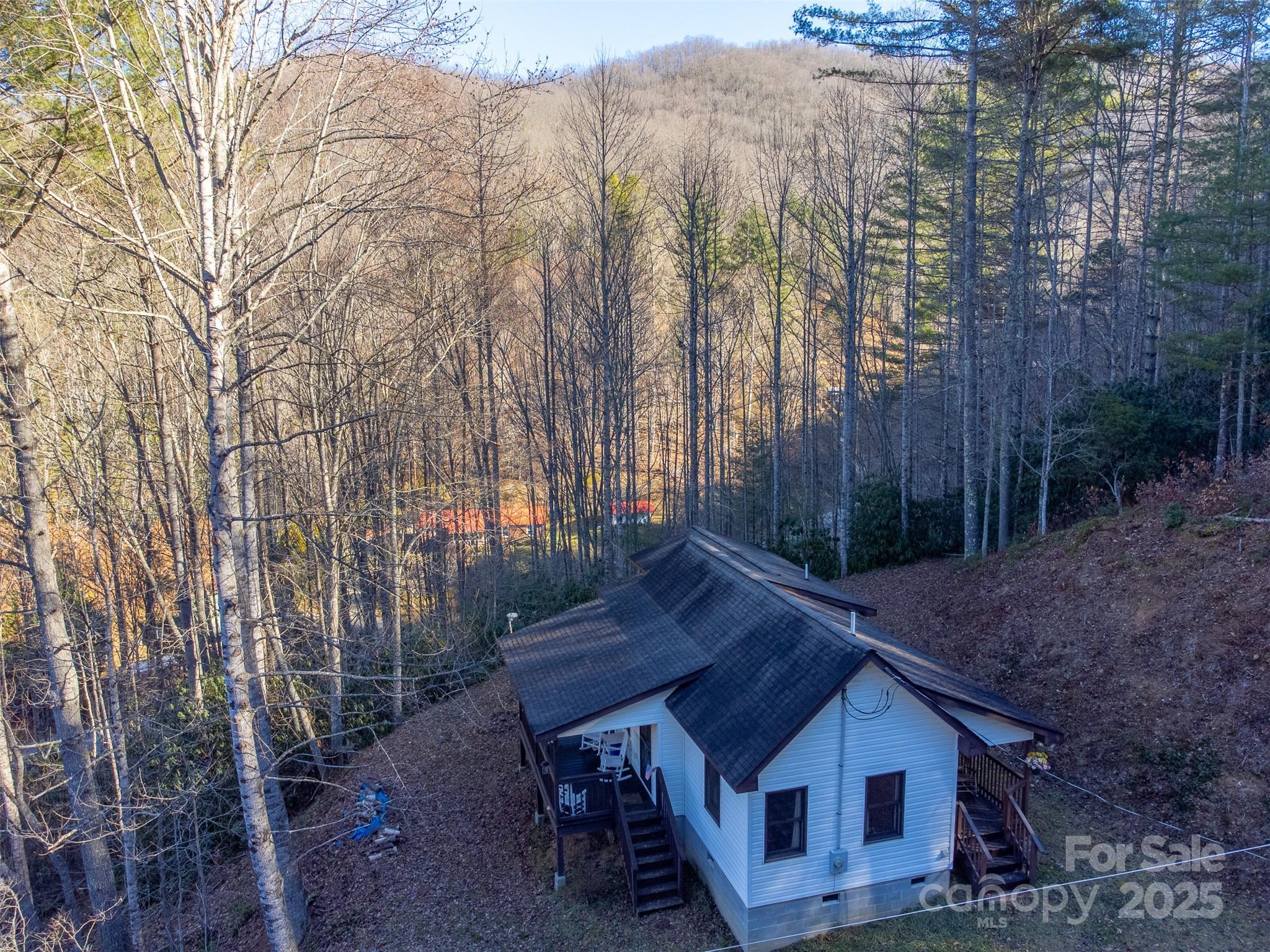 109 Hog Cove Road Sylva, NC 28779 - Photo 42 of 48 a view of backyard with table and chairs and wooden fence