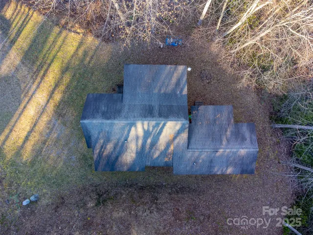 a wooden bench sitting in backyard of a house