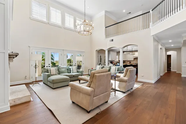 a kitchen with stainless steel appliances kitchen island granite countertop a table chairs refrigerator and cabinets