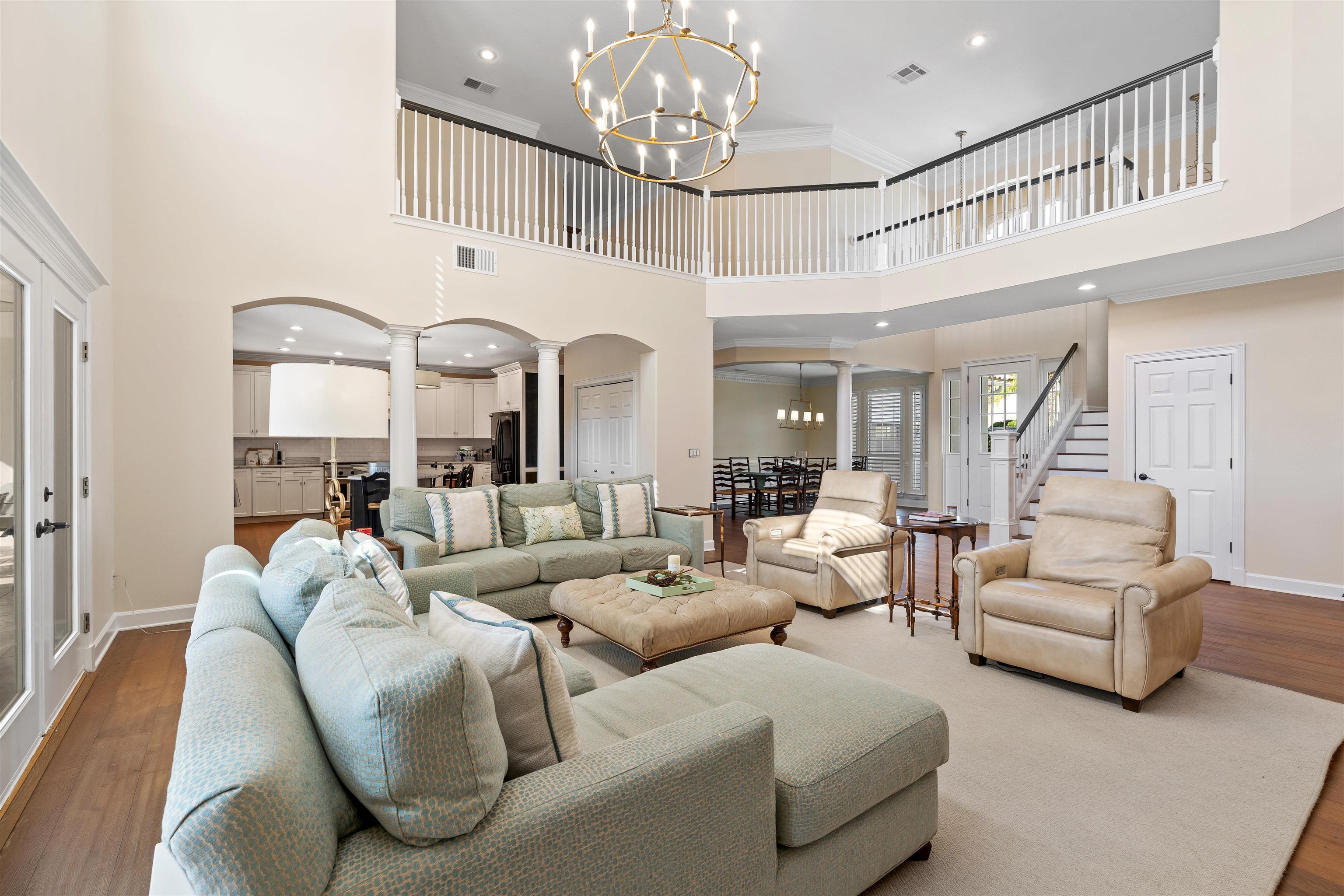 207 Marshside Drive St. Augustine, FL 32080 - Photo 15 of 87 a living room with furniture a chandelier and a dining table