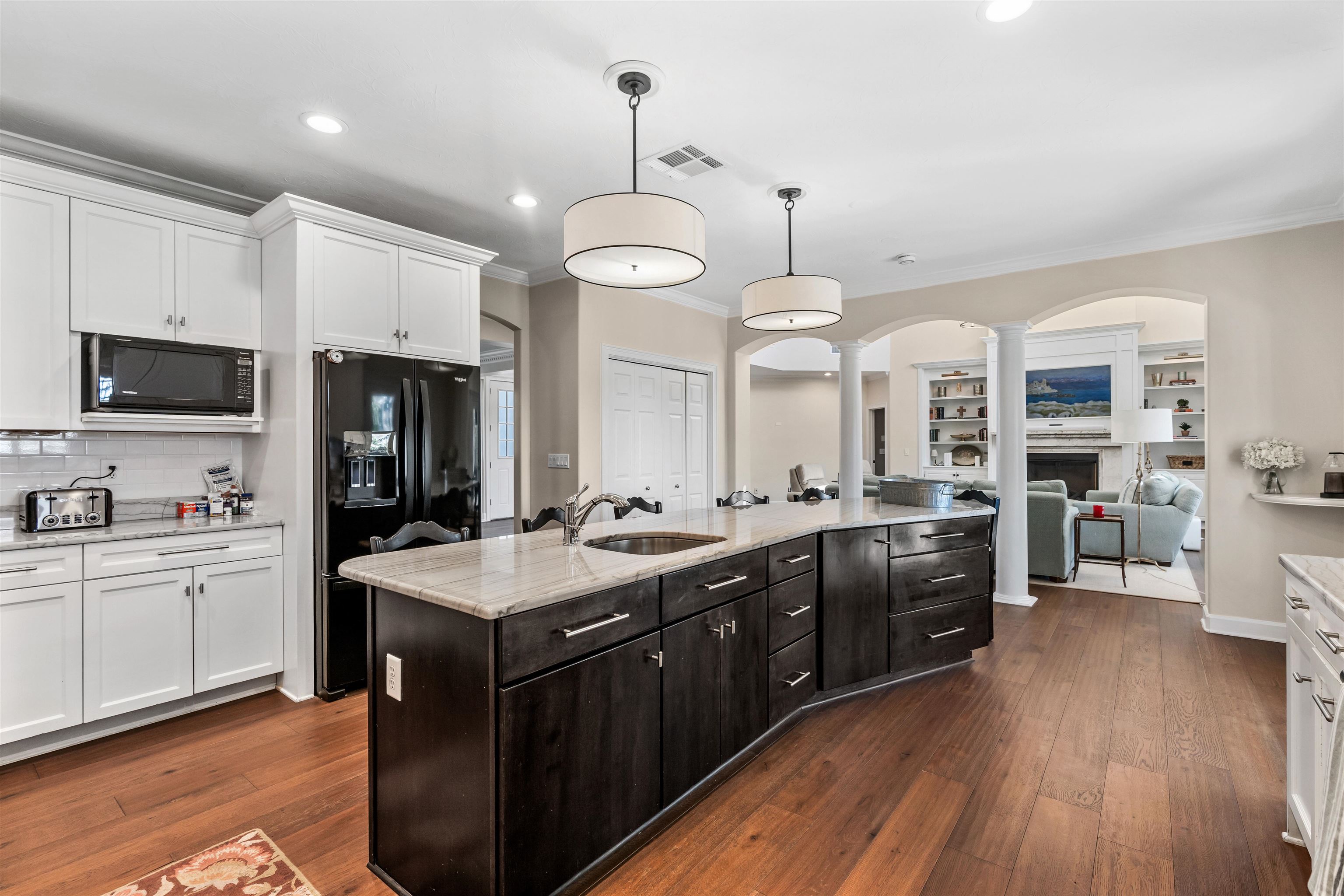 207 Marshside Drive St. Augustine, FL 32080 - Photo 19 of 87 Kitchen with white cabinets, black appliances, pendant lighting, light stone counters, and ornamental molding