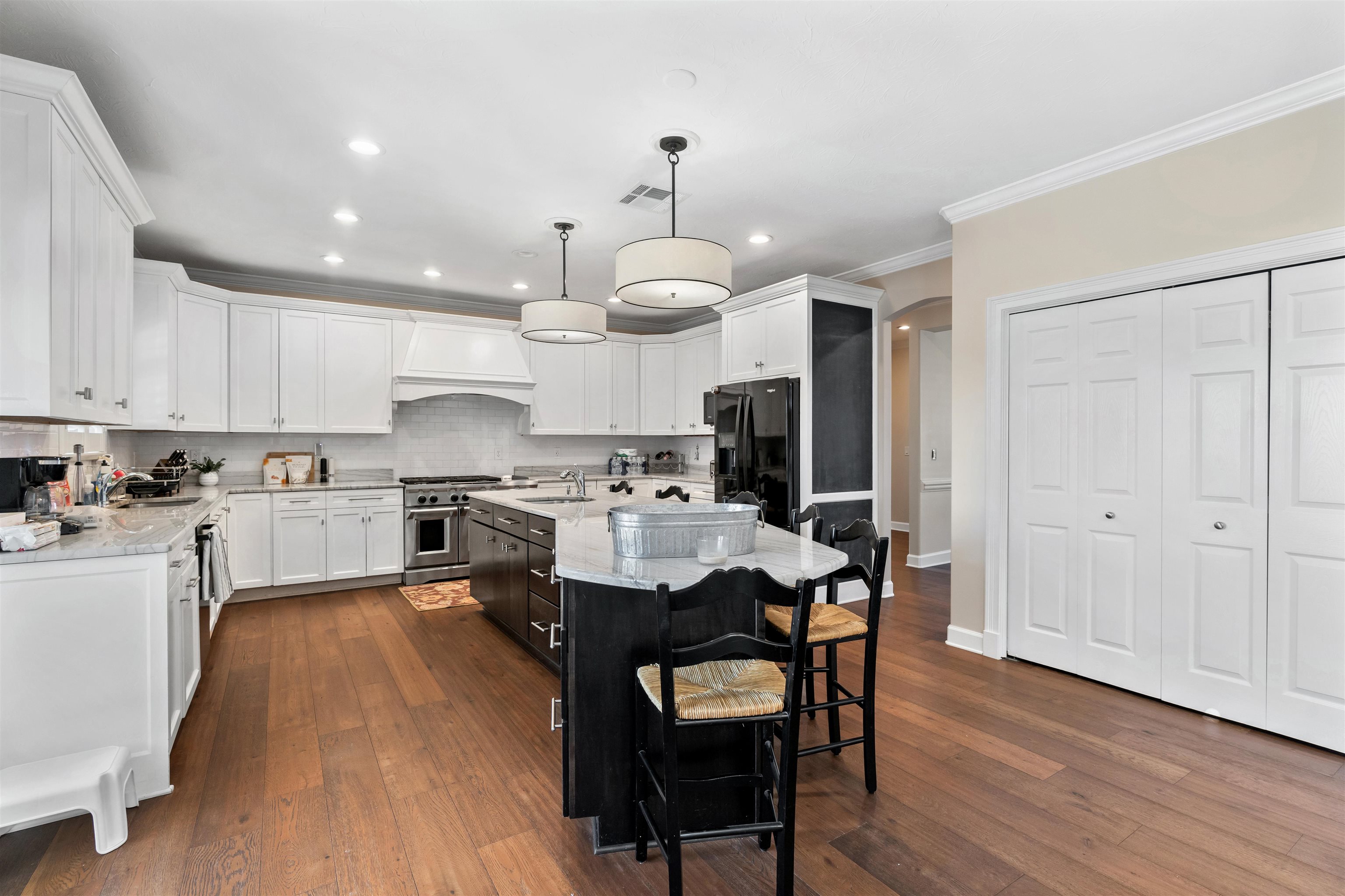 207 Marshside Drive St. Augustine, FL 32080 - Photo 22 of 87 a kitchen with stainless steel appliances kitchen island granite countertop a table chairs refrigerator and cabinets