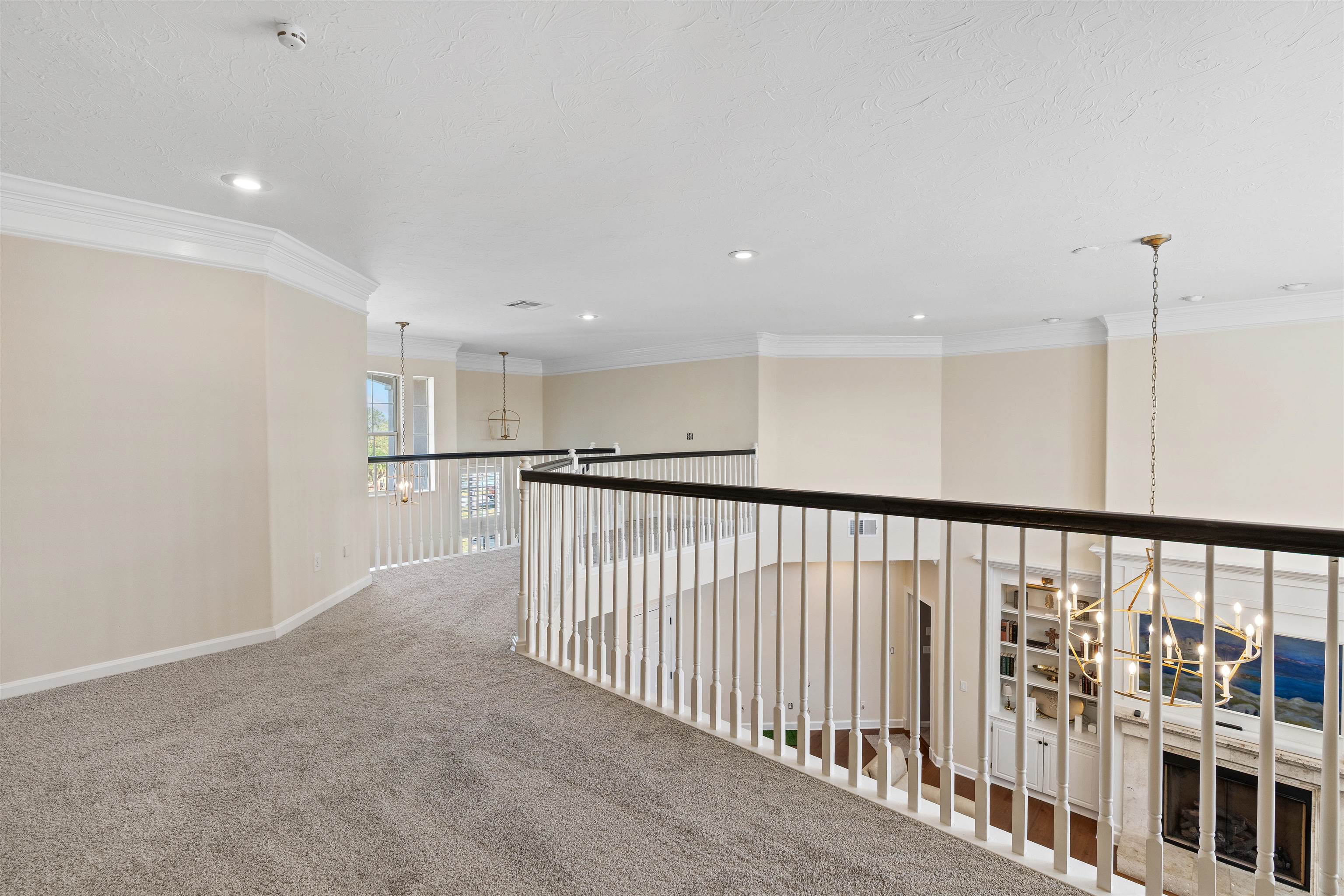 207 Marshside Drive St. Augustine, FL 32080 - Photo 25 of 87 Hallway with a chandelier, crown molding, carpet, and recessed lighting