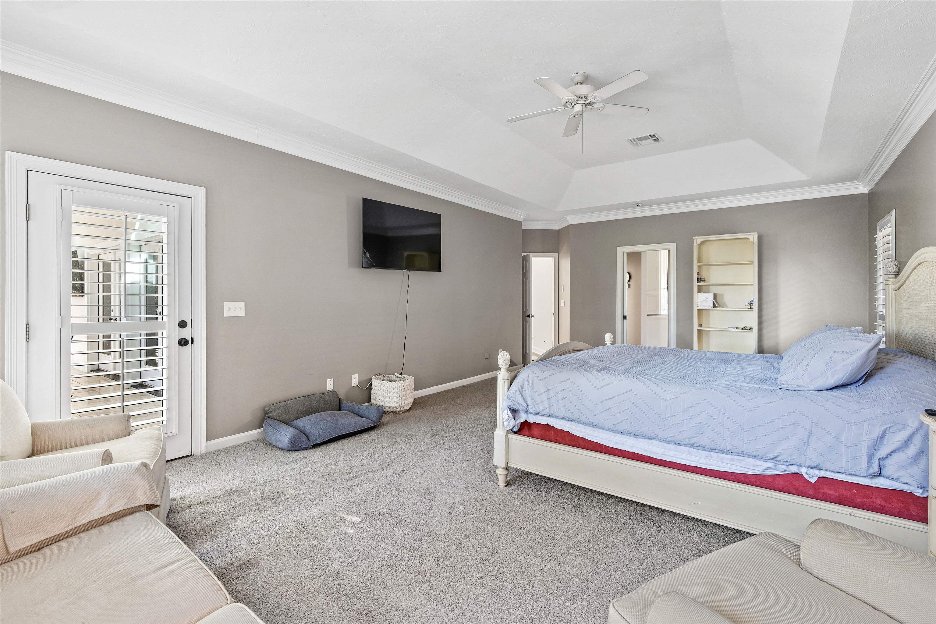 207 Marshside Drive St. Augustine, FL 32080 - Photo 29 of 87 Bedroom with ornamental molding, carpet flooring, a ceiling fan, and a raised ceiling