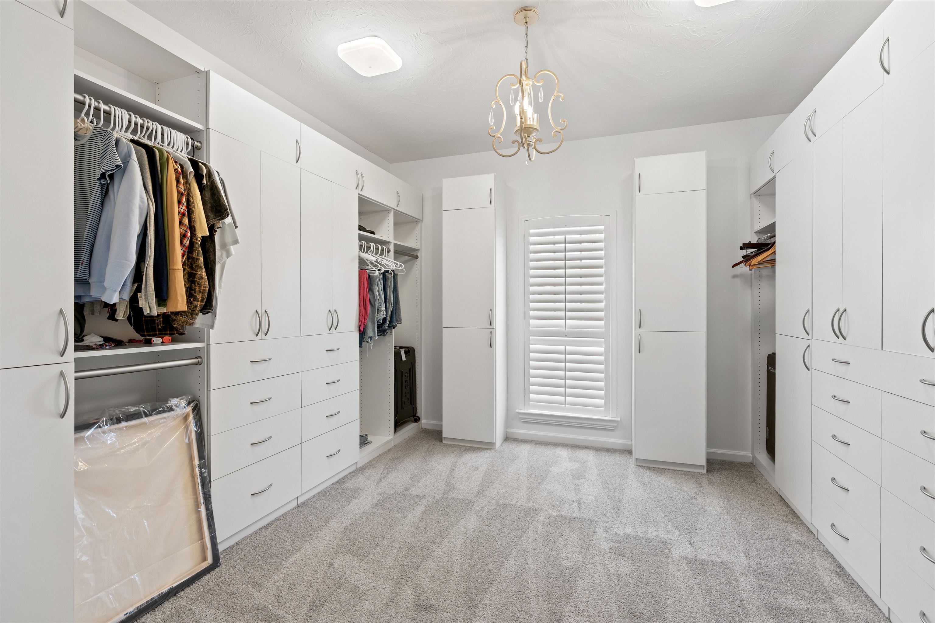 207 Marshside Drive St. Augustine, FL 32080 - Photo 31 of 87 Walk in closet featuring a chandelier and light colored carpet