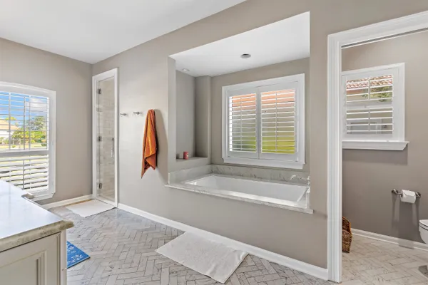a bathroom with a toilet sink vanity and mirror