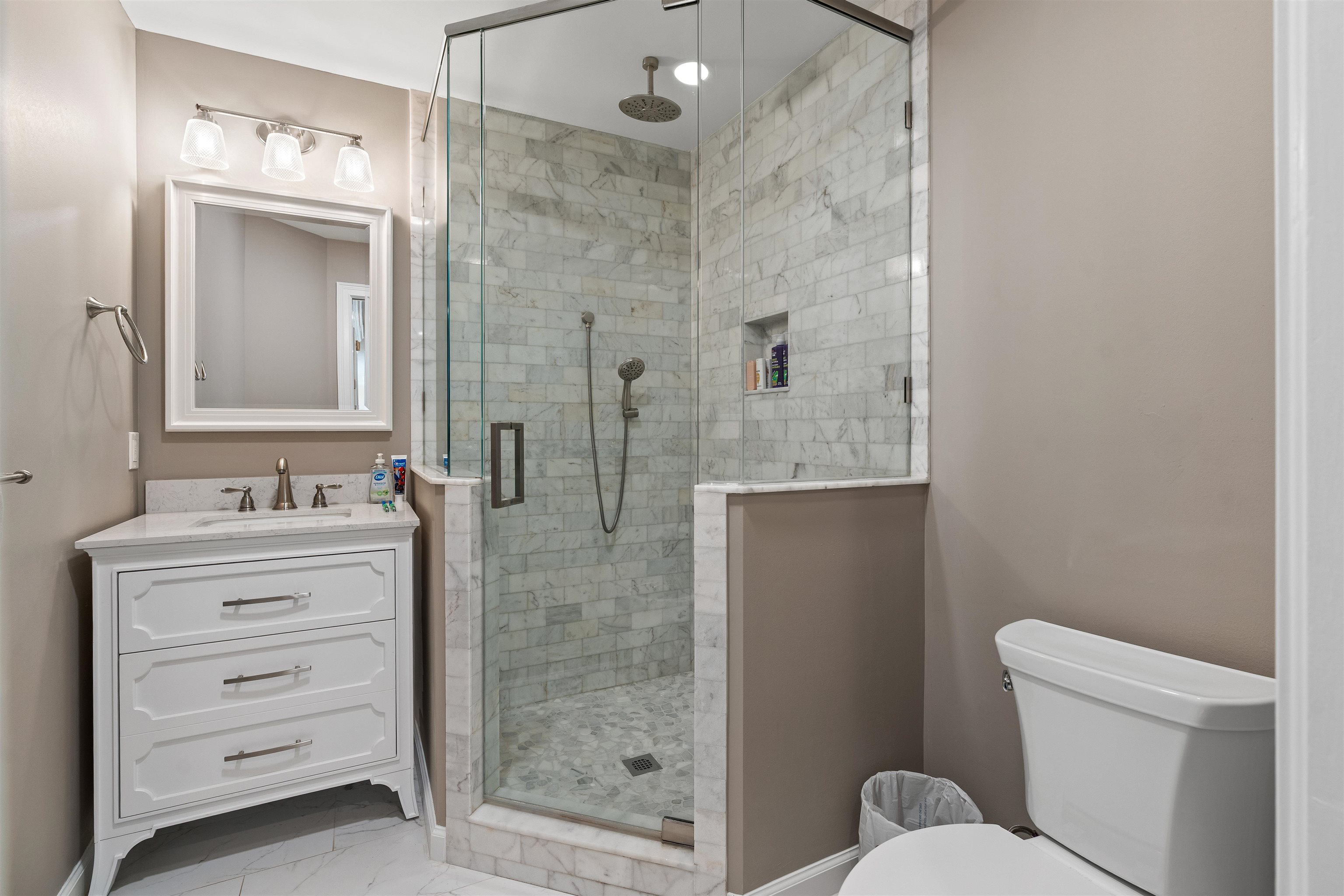 207 Marshside Drive St. Augustine, FL 32080 - Photo 39 of 87 Full bath featuring vanity, light marble finish floors, and a stall shower