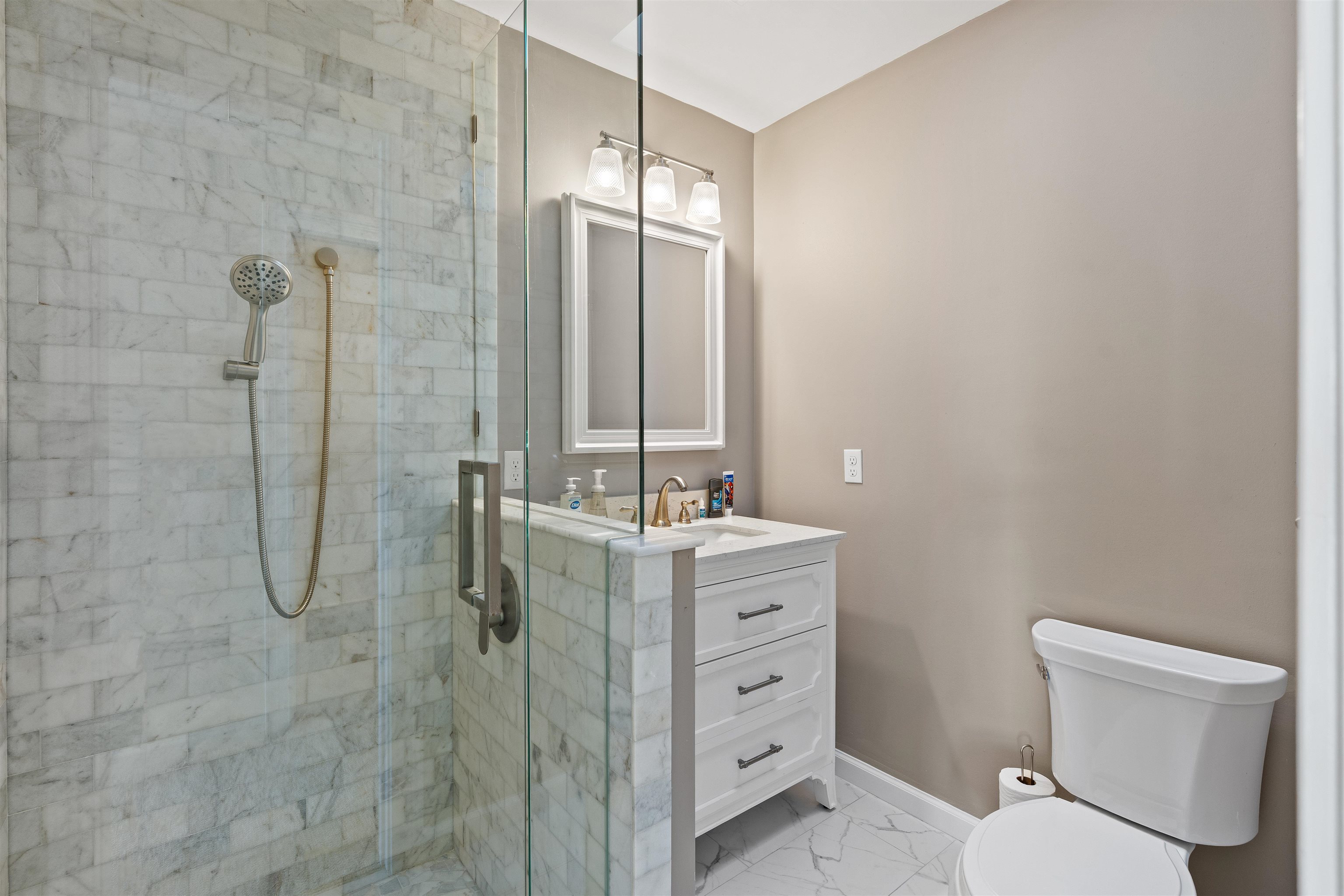 207 Marshside Drive St. Augustine, FL 32080 - Photo 45 of 87 a bathroom with a granite countertop sink toilet and shower