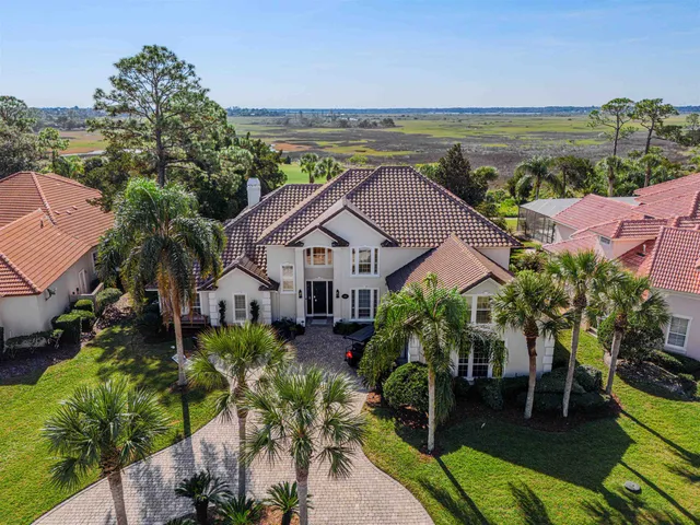 an aerial view of a house with a swimming pool and sitting area