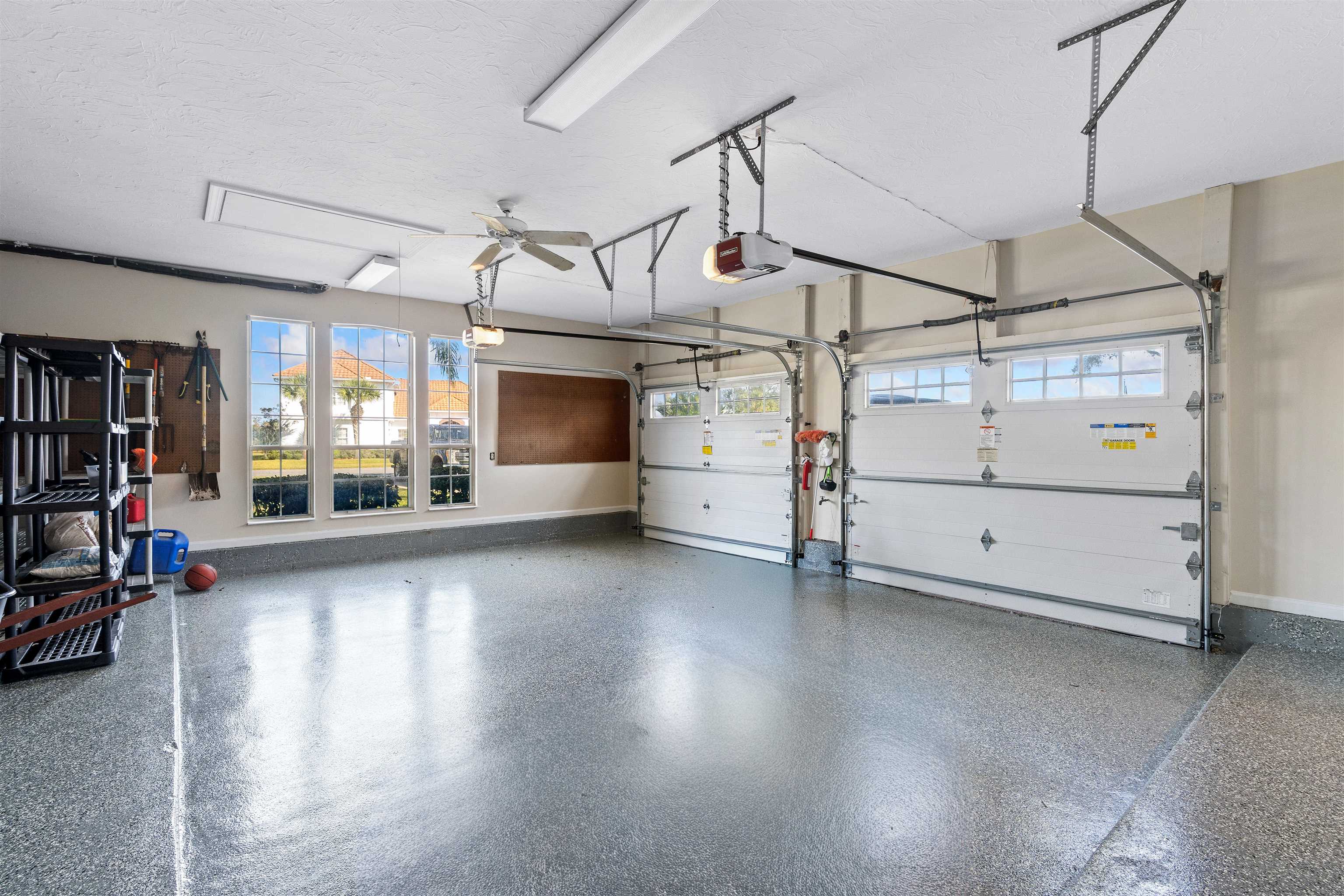 207 Marshside Drive St. Augustine, FL 32080 - Photo 62 of 87 Garage featuring a ceiling fan and a garage door opener