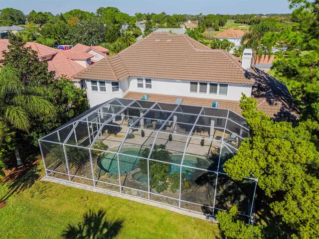 an aerial view of a house with a yard and garden