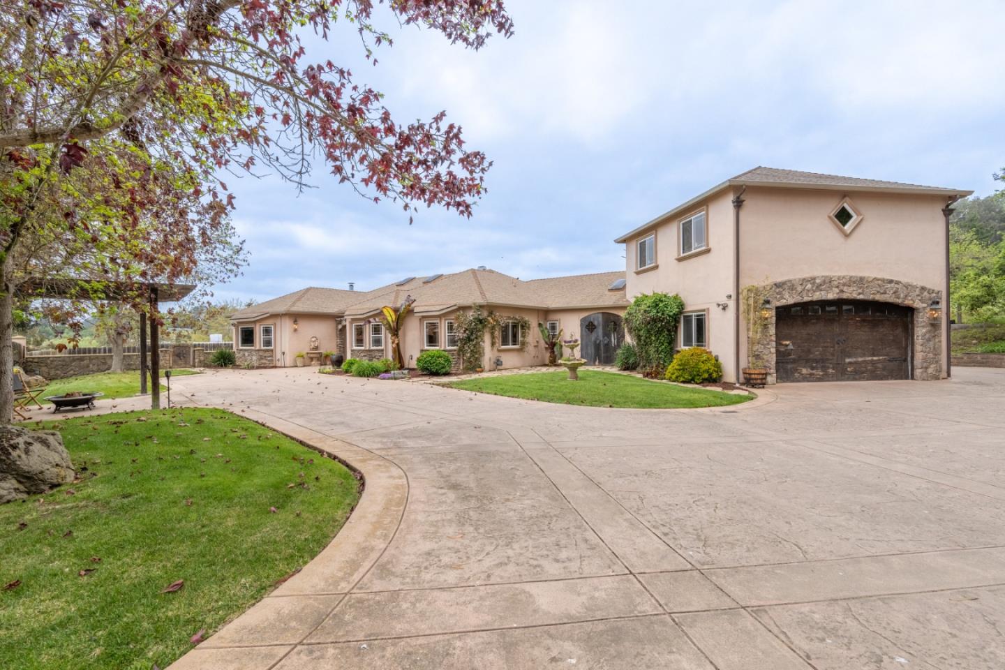 a view of house with garden and tall tress