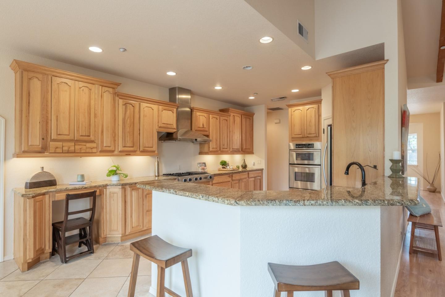 10233 Reese Circle Salinas, CA 93907 - Photo 11 of 49 a kitchen with stainless steel appliances granite countertop a sink a stove a refrigerator cabinets and chairs