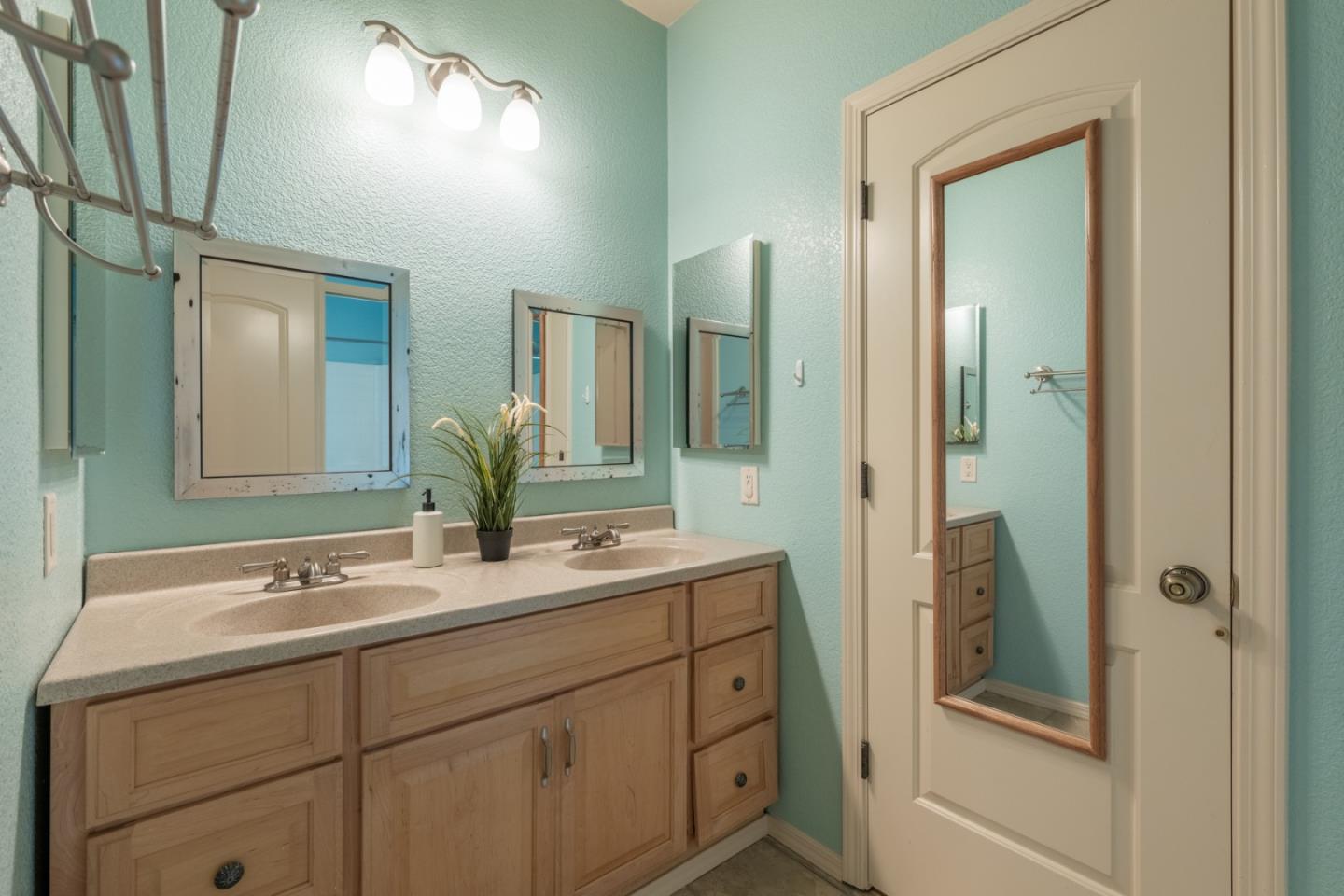 10233 Reese Circle Salinas, CA 93907 - Photo 25 of 49 a bathroom with a double vanity sink and mirror