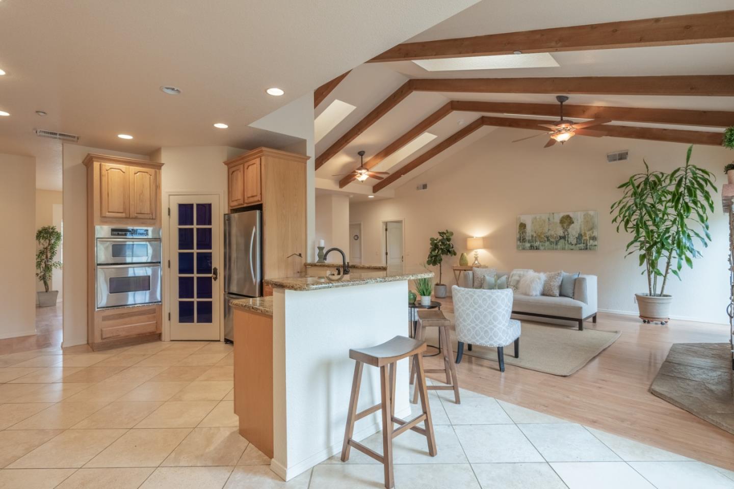 10233 Reese Circle Salinas, CA 93907 - Photo 8 of 49 a living room with furniture a chandelier and kitchen view