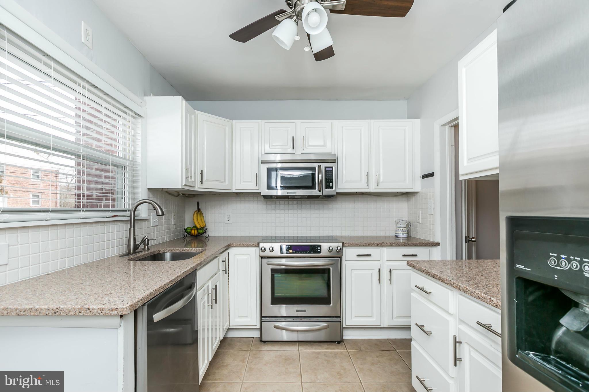 1947 Edgewood Road Baltimore, MD 21286 - Photo 11 of 28 a kitchen with granite countertop a stove sink and cabinets