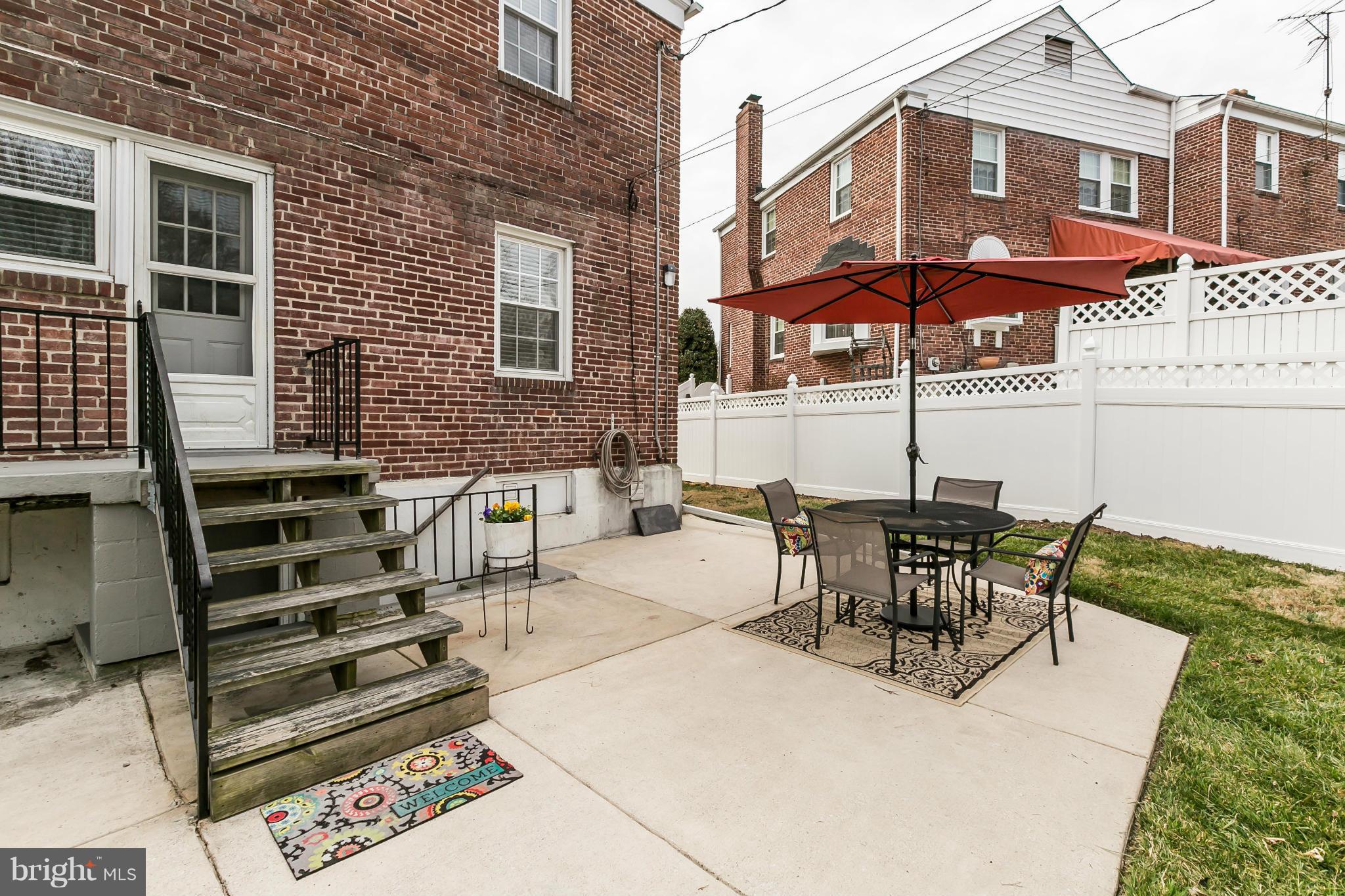 1947 Edgewood Road Baltimore, MD 21286 - Photo 24 of 28 a view of a patio with table and chairs under an umbrella