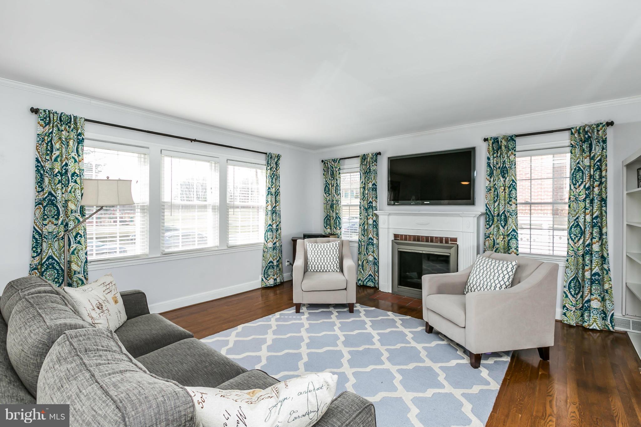 1947 Edgewood Road Baltimore, MD 21286 - Photo 6 of 28 a living room with furniture a flat screen tv and a fireplace