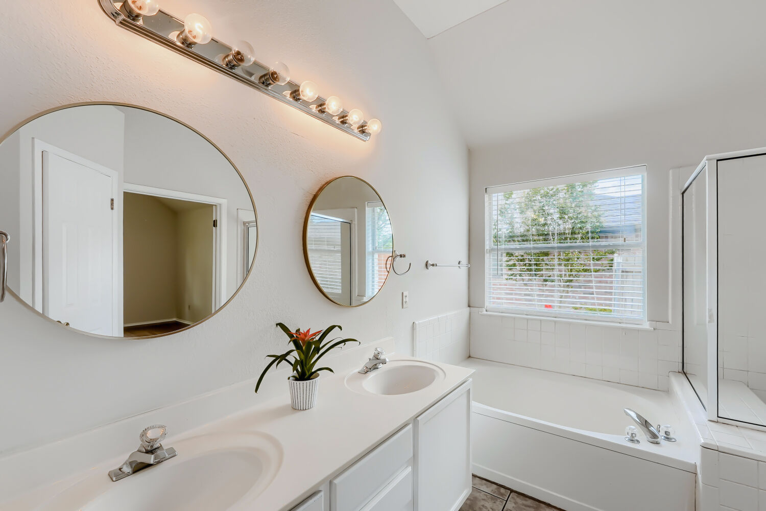 119 Stephen Lane Georgetown, TX 78626 - Photo 10 of 32 Bright, refreshed bathroom featuring a vanity with dual sinks, a large window, walk in shower and soaking tub.
