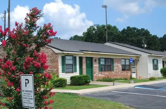 a front view of a house with a yard and potted plants