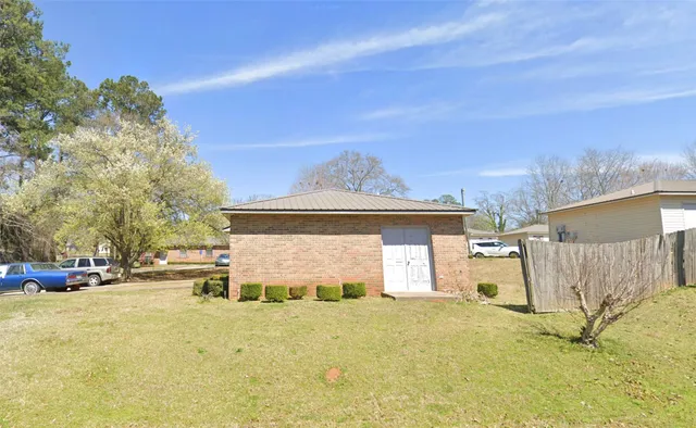 a front view of a house with a yard covered with snow
