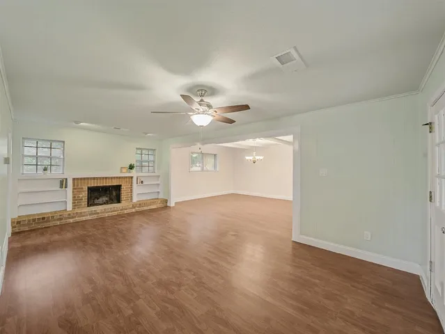 wooden floor in an empty room with a fireplace