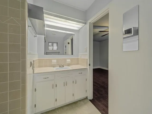 a bathroom with a granite countertop sink a mirror and a