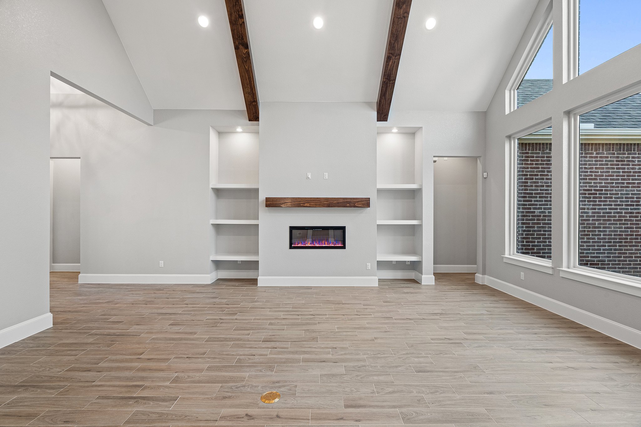 112 Axis Loop Georgetown, TX 78628 - Photo 5 of 39 an empty room with wooden floor and fireplace