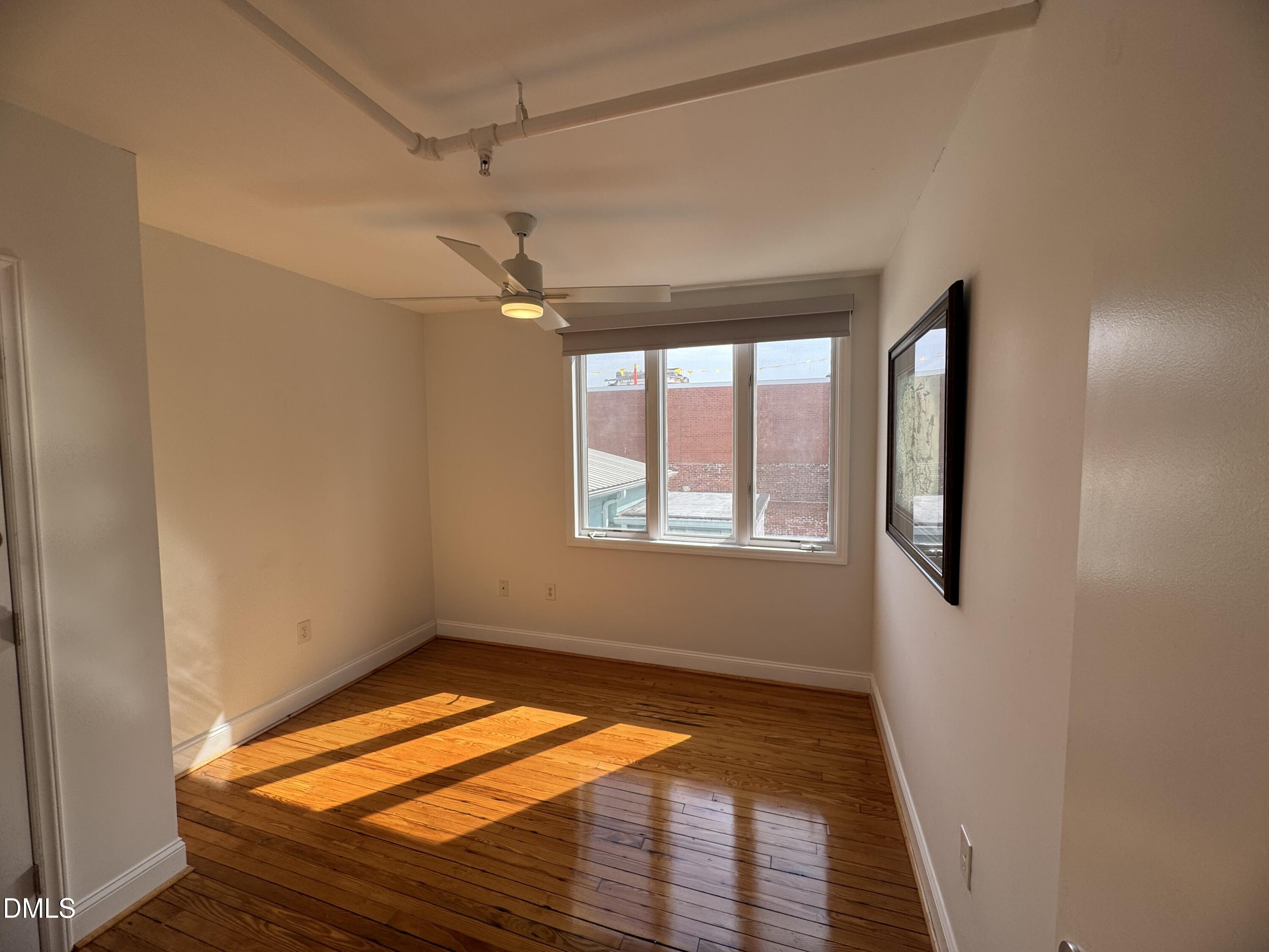 109 West Main Street, Unit 402 Durham, NC 27701 - Photo 12 of 19 a view of empty room with window and ceiling fan