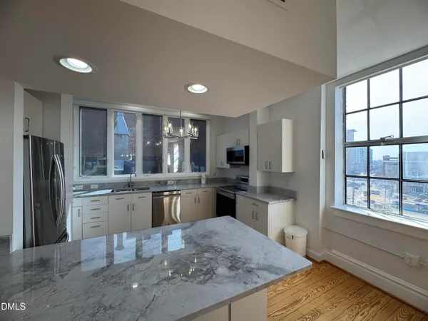 a kitchen with refrigerator and window
