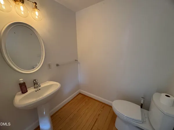a bathroom with a sink mirror and toilet