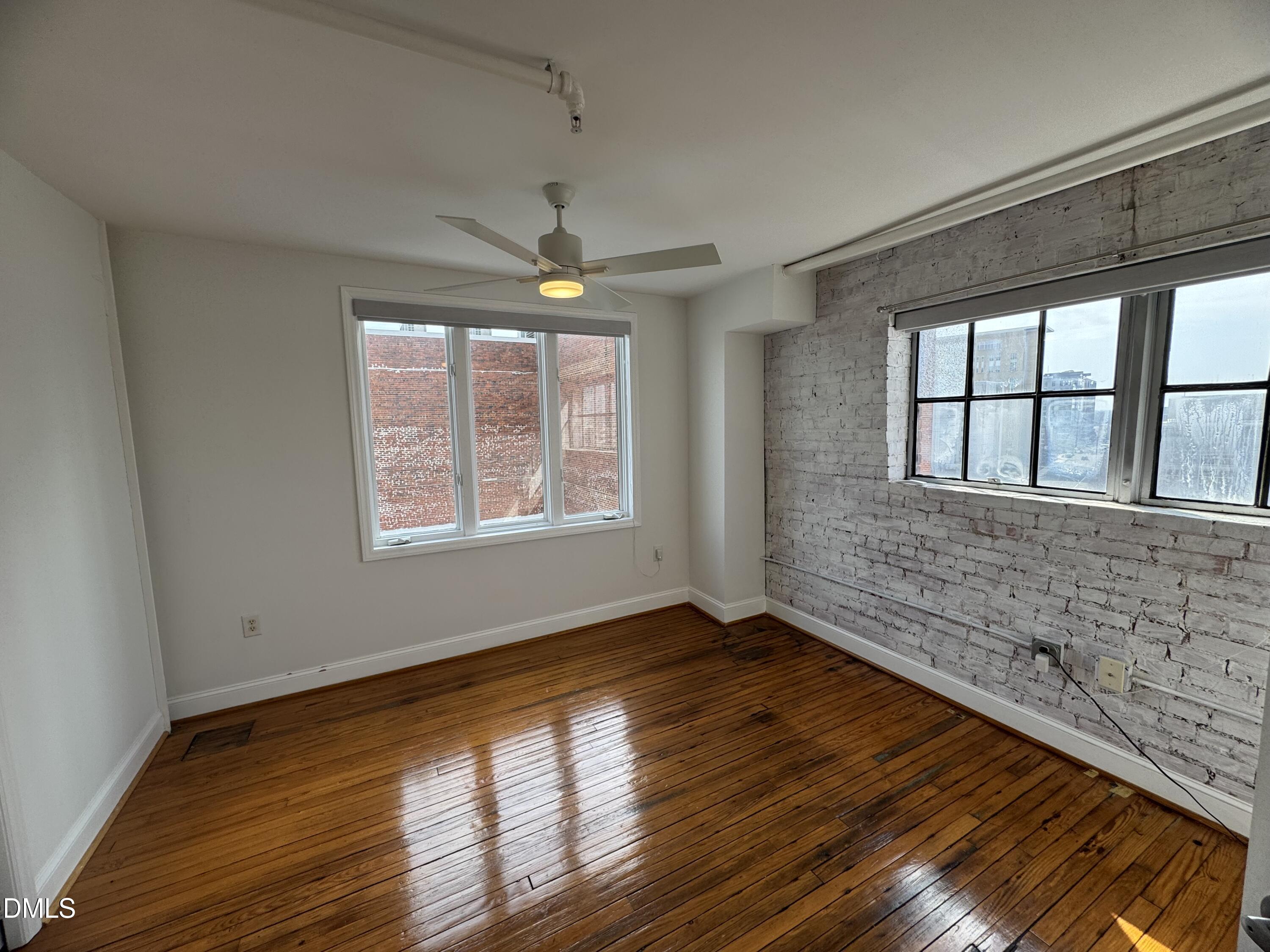 109 West Main Street, Unit 402 Durham, NC 27701 - Photo 10 of 19 a view of an empty room with wooden floor and a window
