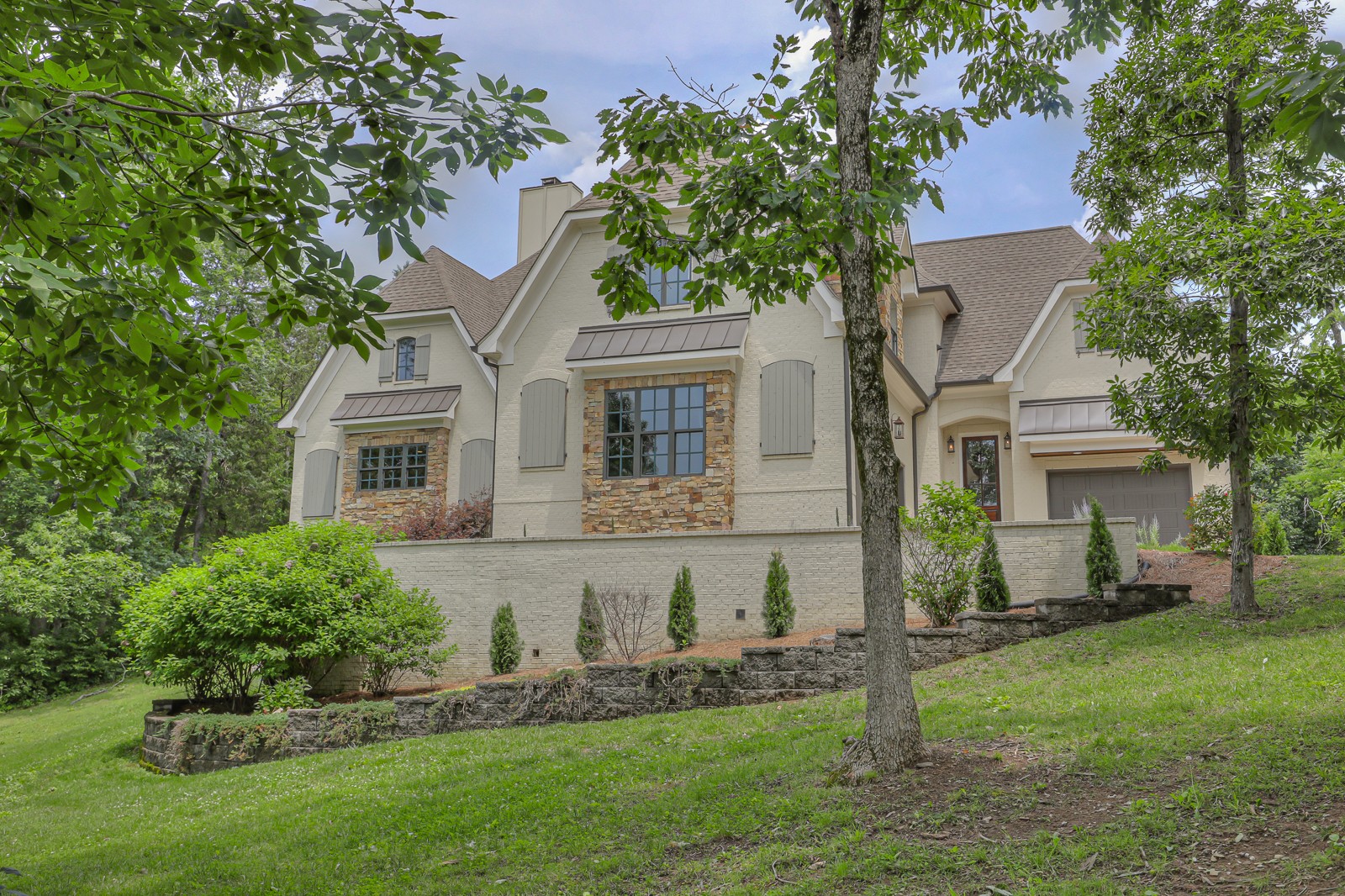 4554 Peytonsville Road Franklin, TN 37064 - Photo 1 of 29 a front view of a house with a garden and plants