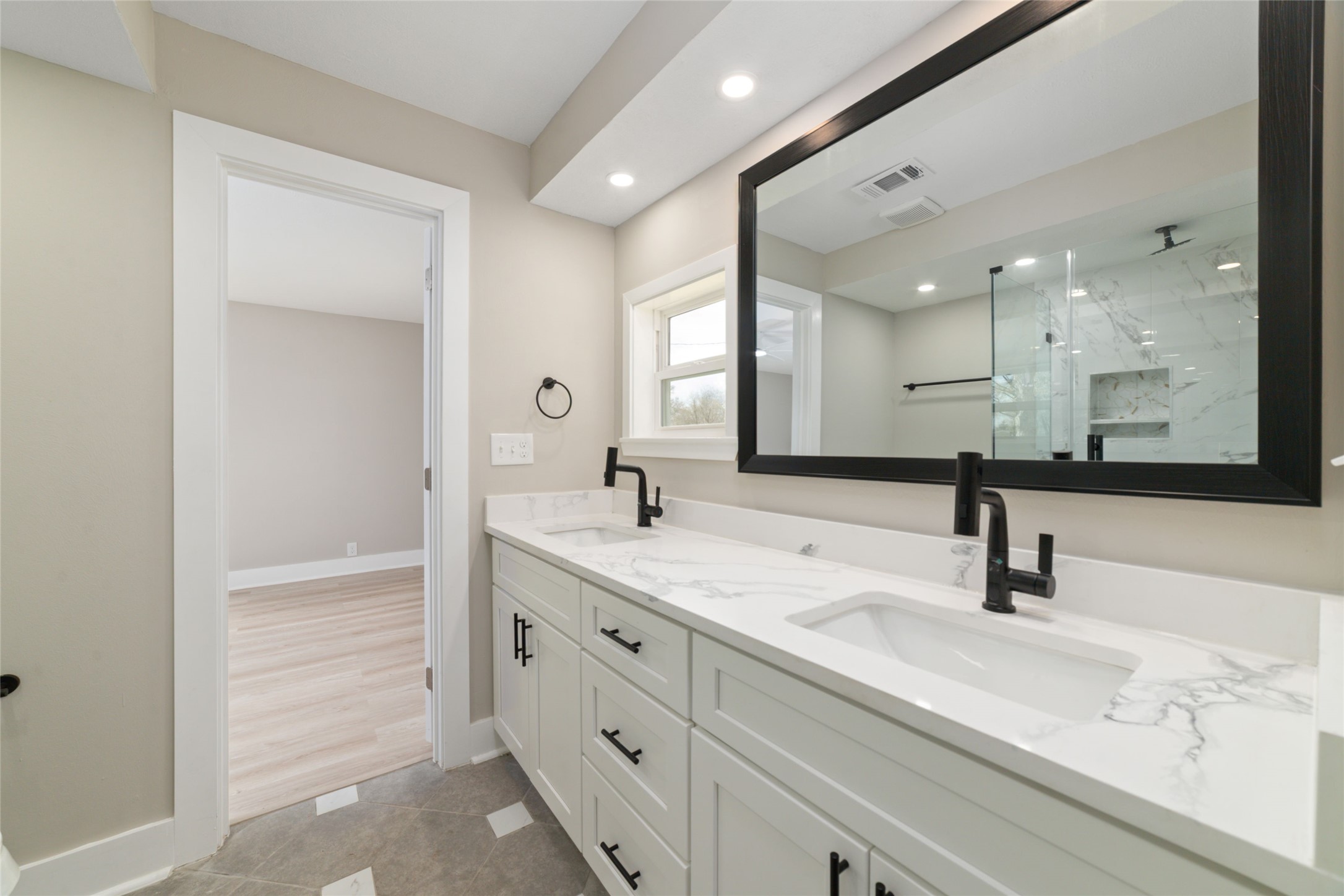 13431 Vrlla Road Guy, TX 77444 - Photo 14 of 32 a bathroom with double vanity sink and mirror
