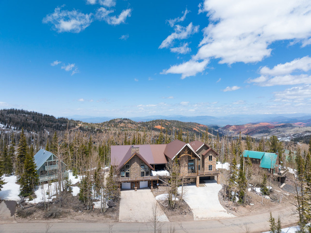 382 Ridgeview Street, Unit 8 & 9 Brian Head, UT 84719 - Photo 5 of 52 Stone and wood-clad mountain home with a rich brown roof