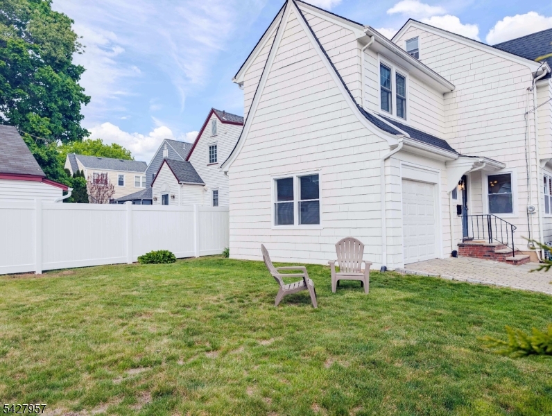 909 Ridgewood Road Millburn, NJ 07041 - Photo 27 of 33 a backyard of a house with table and chairs