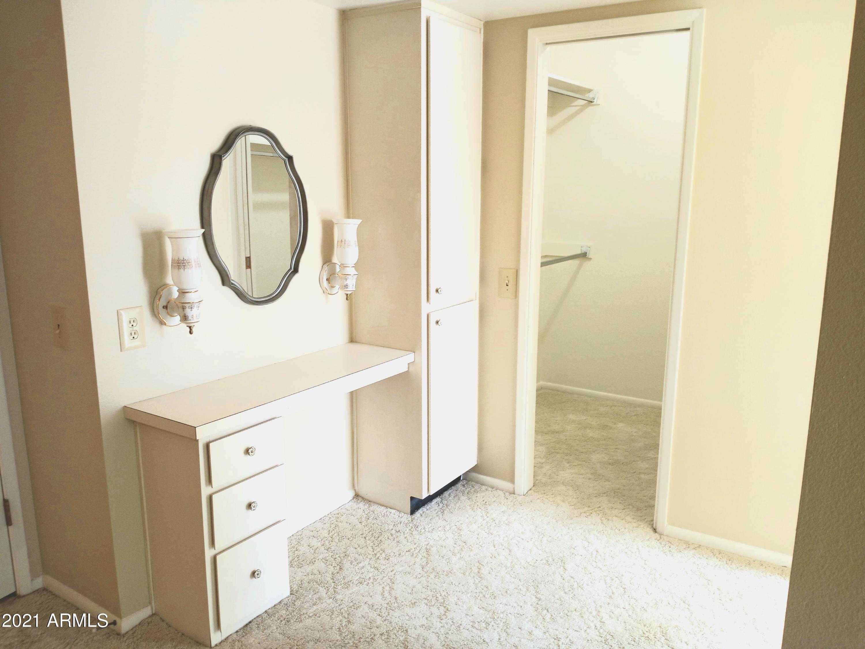 9705 West Oak Ridge Drive Sun City, AZ 85351 - Photo 26 of 35 Master Bedroom, Vanity, Walk In Closet